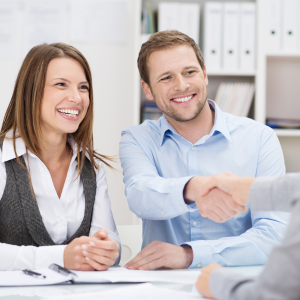Young couple signing documents to buy a house