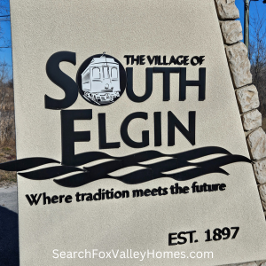 Angular stone sign with the Name and motto of South Elgin eyched in to it